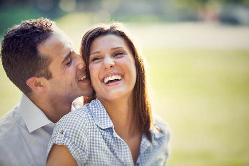 young brunette couple having fun together at the park